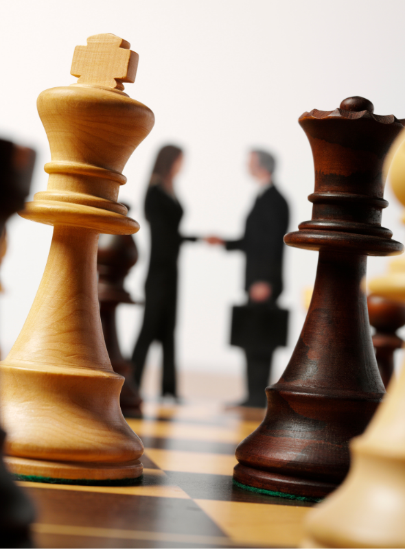 Businessman and women in the background standing on a chess board with chess piece strategy